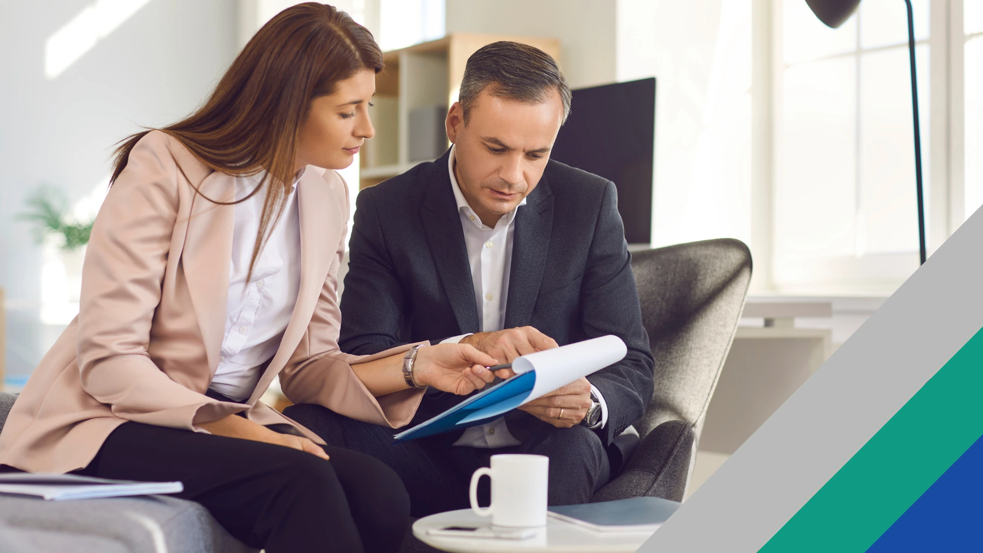A couple looking at a consumer proposal pros and cons document as they sit on a couch