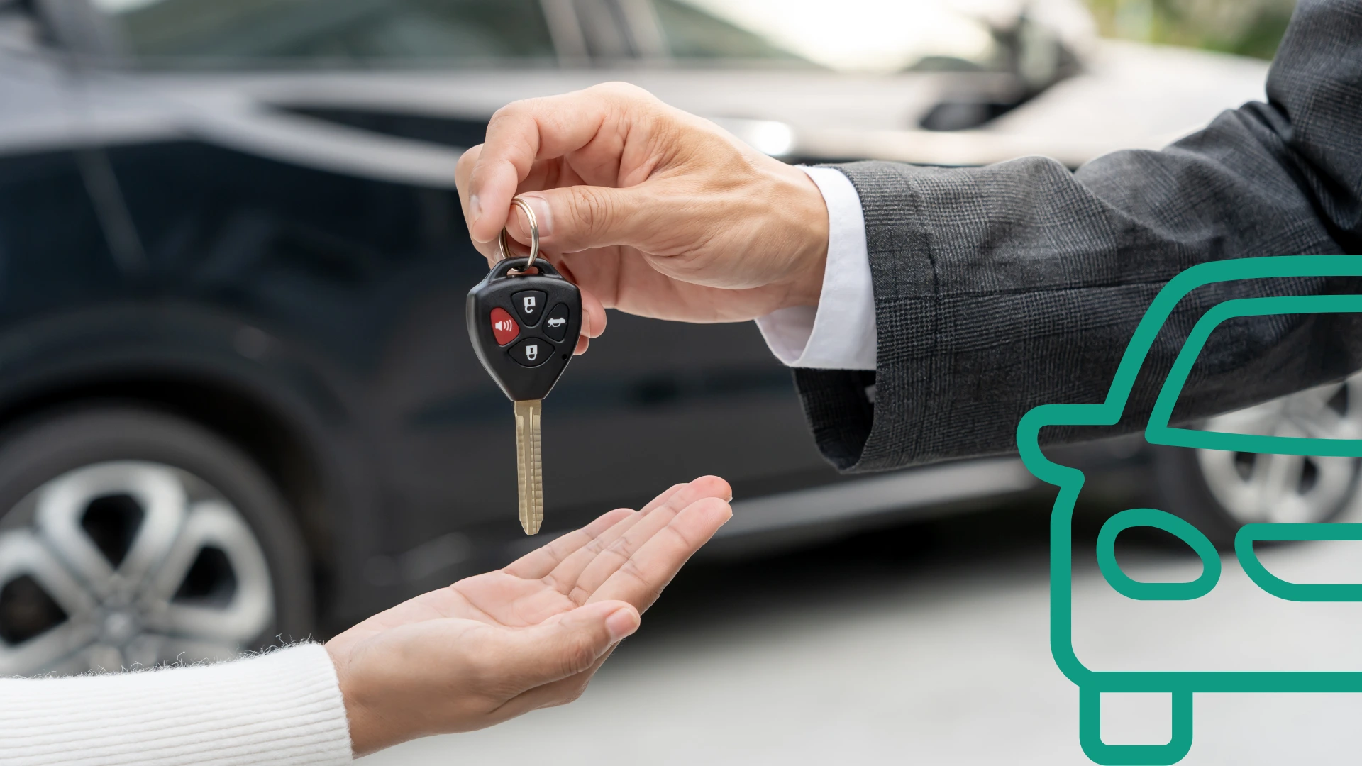 A mans hand, giving car keys to another hand with a vehicle in the background.